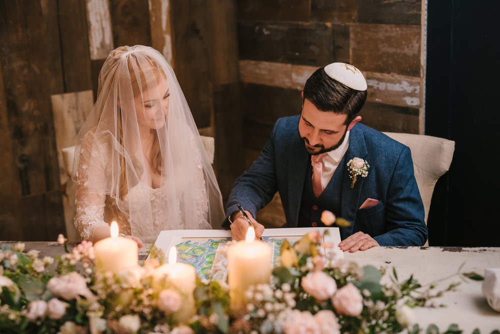 5. A photo of witnesses signing a Ketubah at a Jewish wedding